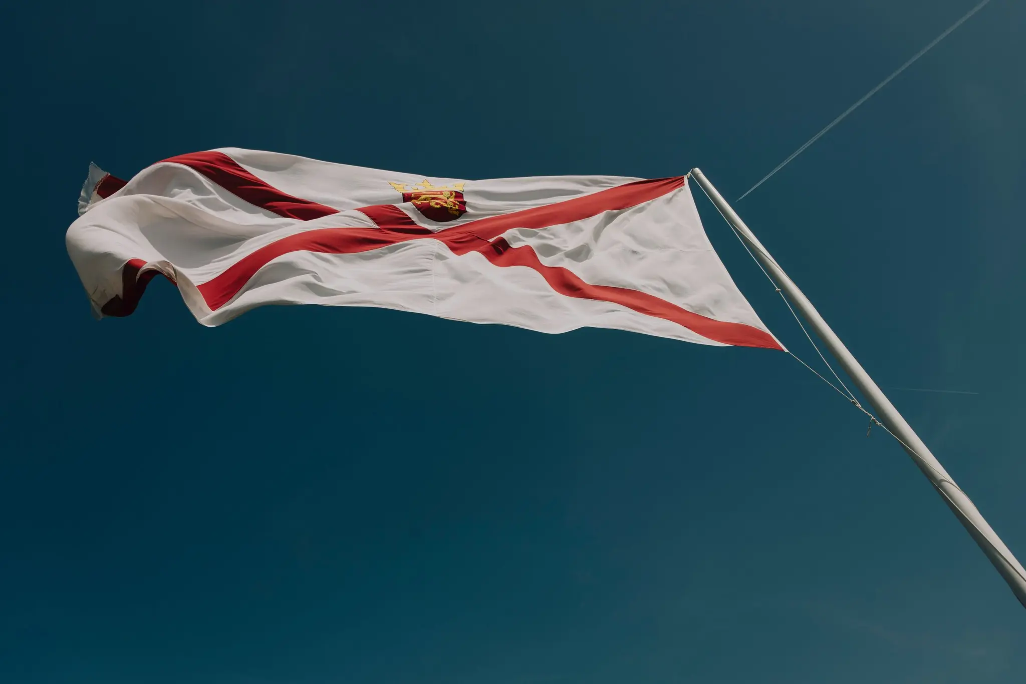 Jersey’s flag flying against a blue sky
